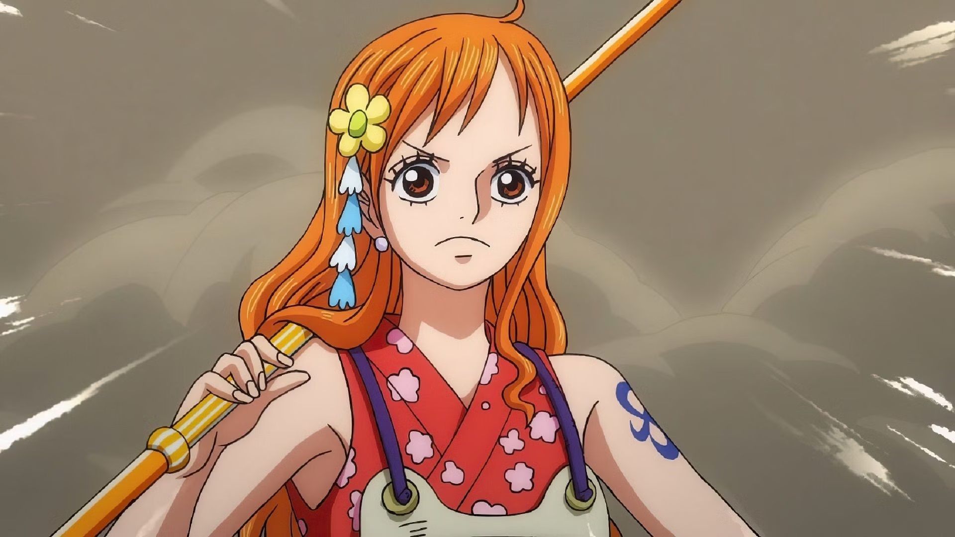 nami in her red wano outfit while carrying a staff