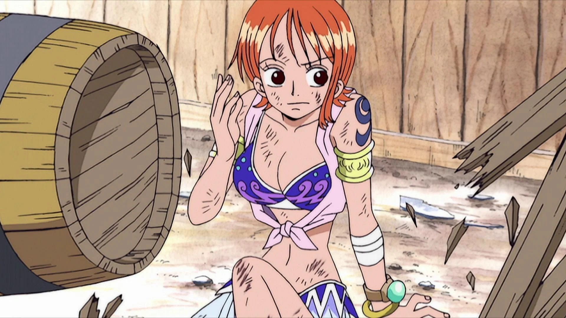 Nami sits on the street next to a barrel