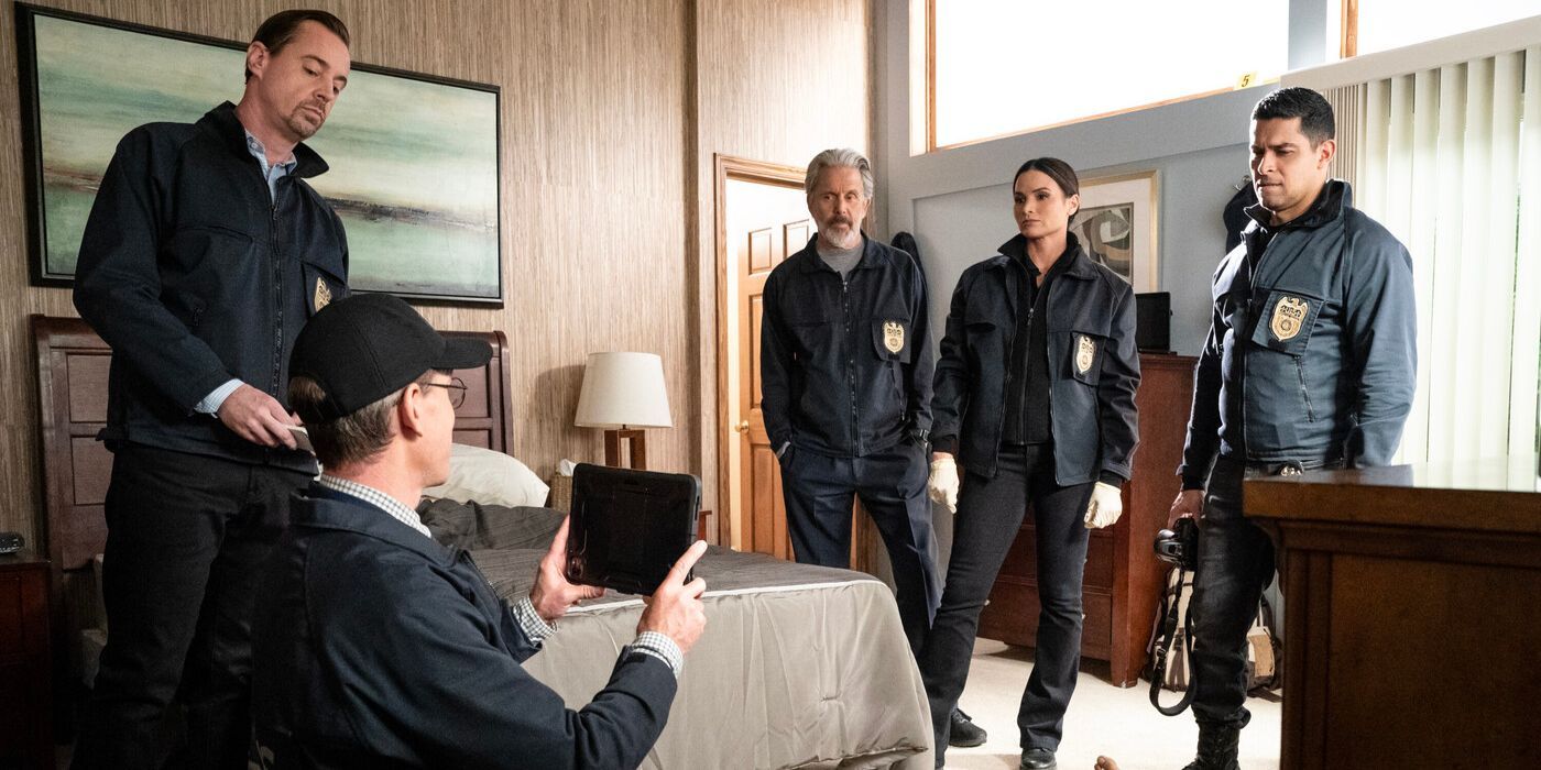 The NCIS agents in black jackets standing in a bedroom crime scene on NCIS