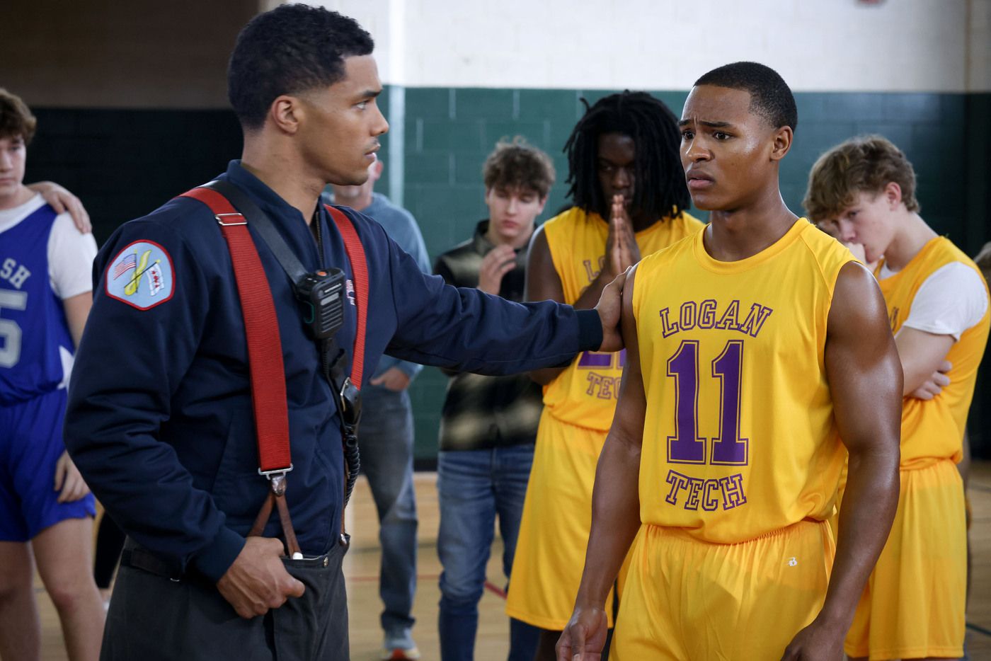 Derrick Gibson (actor Rome Flynn) puts his hand on basketball player Marcus in Chicago Fire