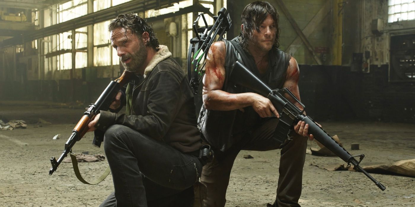 Rick Grimes and Daryl Dixon holding guns in an abandoned warehouse on The Walking Dead