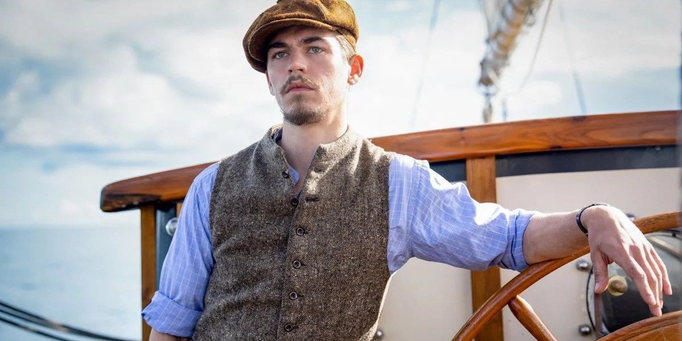 Hero Fiennes Tiffin as Henry Hayes stands on a boat readt for a mission