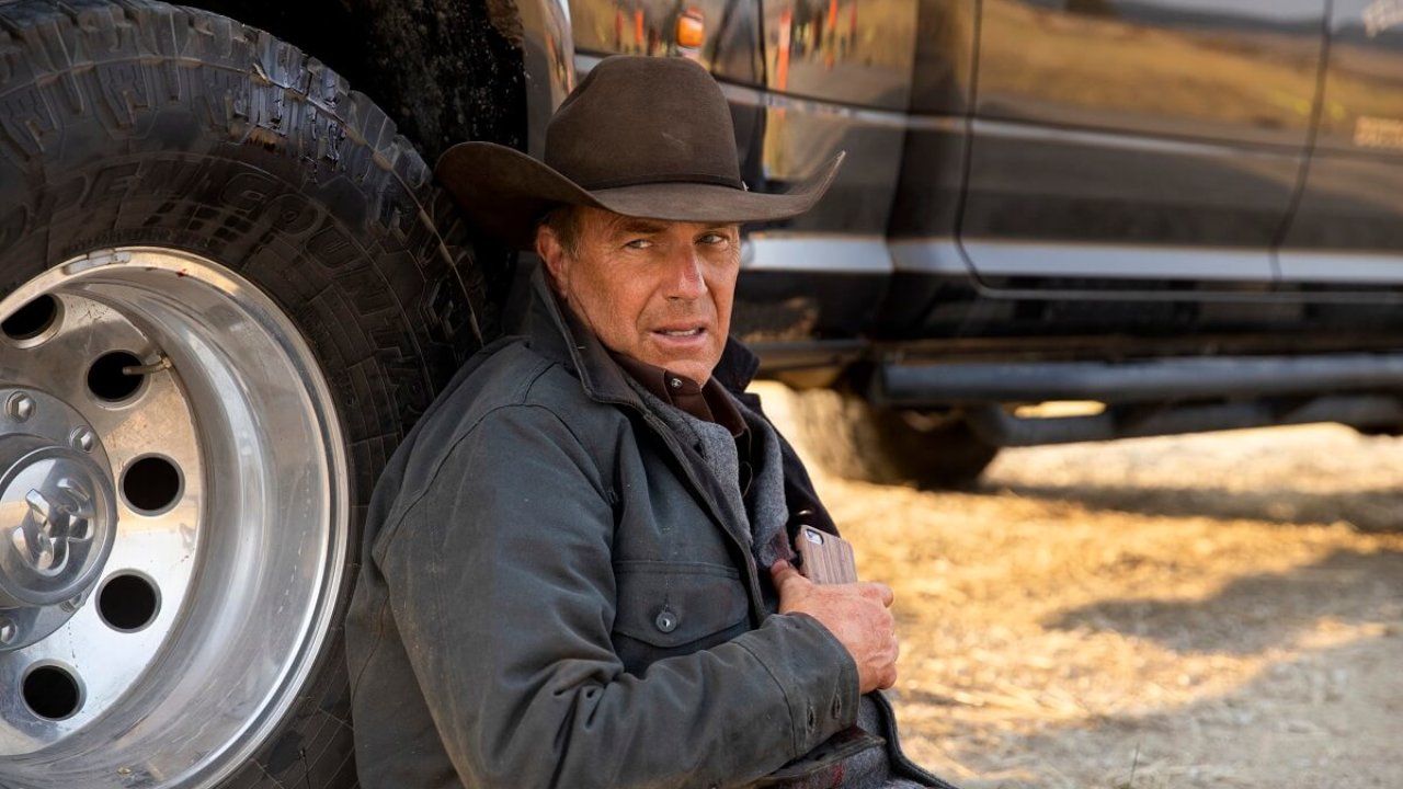 John Dutton (Kevin Costner) laying against a tire in Yellowstone: "Half the Money"