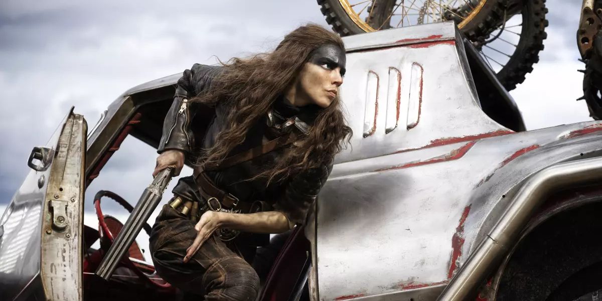 Anya Taylor-Joy exits a vehicle with a shotgun as Furiosa in Furiosa A Mad Max Saga