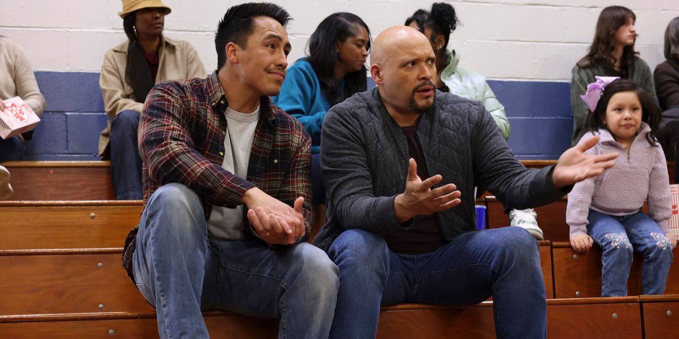 Joe Cruz (actor Joe Minoso, right) reacts to a basketball game next to Dennis on Chicago Fire