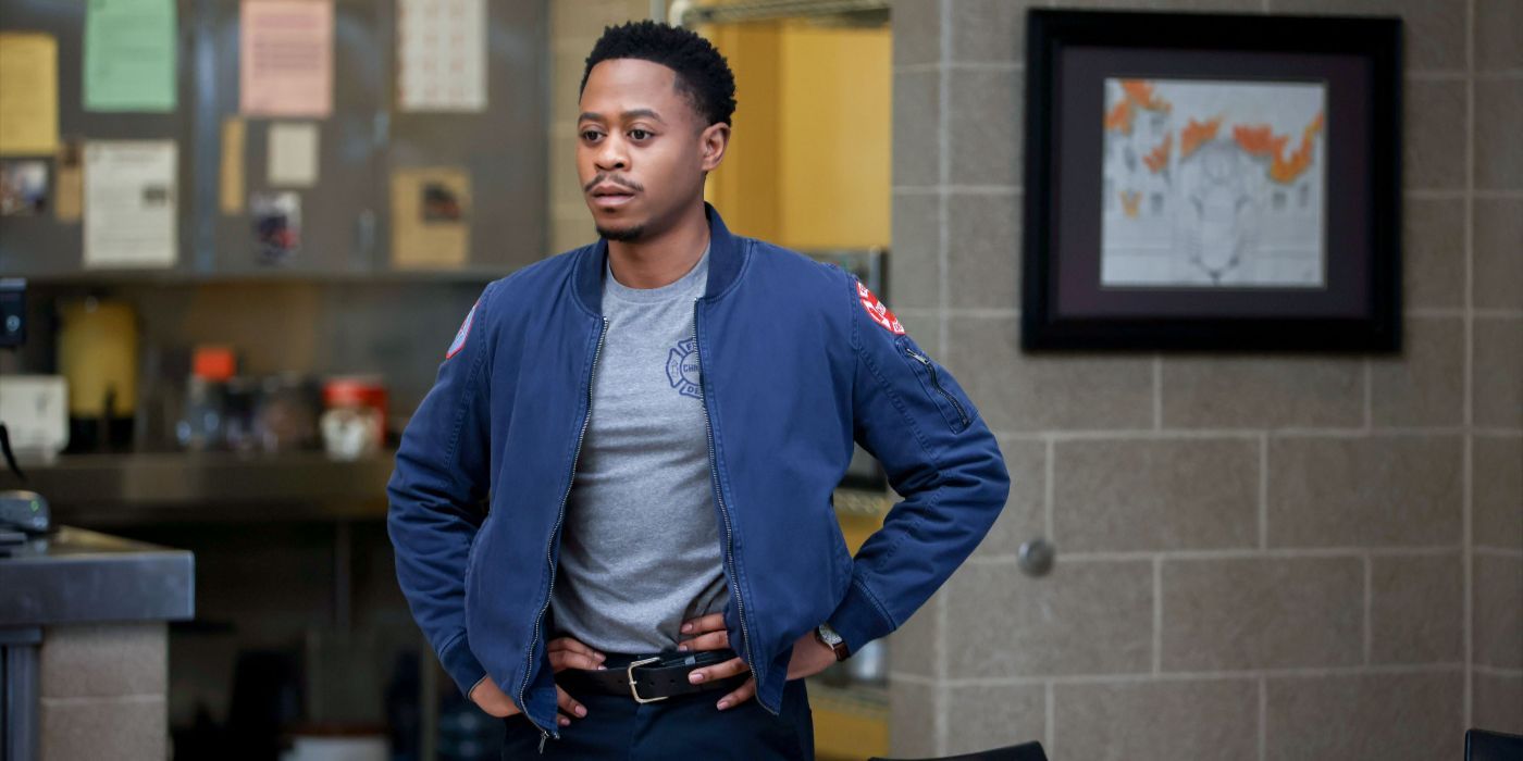 Darren Ritter (actor Daniel Kyri) stands with hands on hips in CFD jacket on Chicago Fire