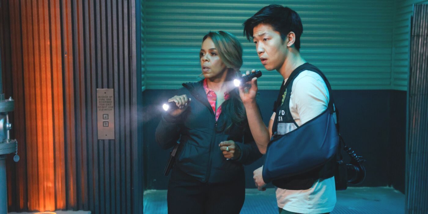 Maxine Roby (actor Paula Newsome) and Chris Park (Jay Lee) shine flashlights in bunker in CSI: Vegas
