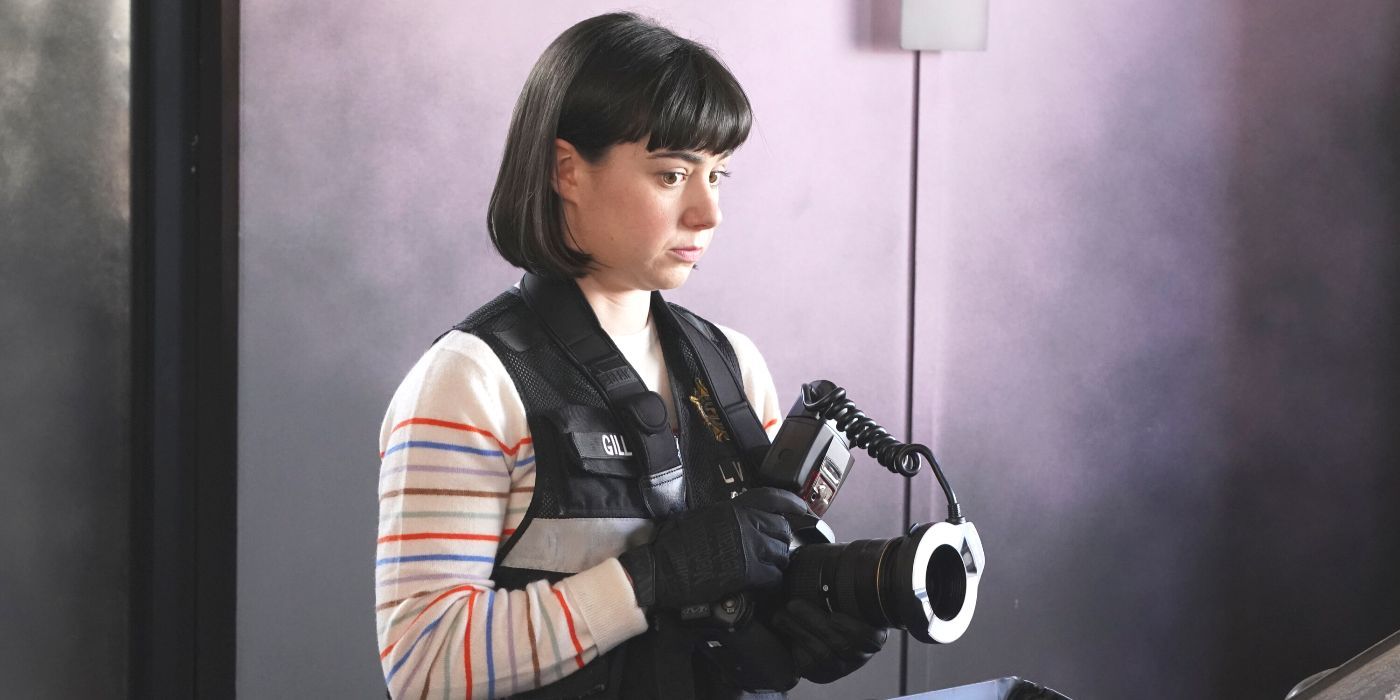 Penny Gill (actor Sarah Gilman) wearing a CSI vest holding a camera in CSI: Vegas