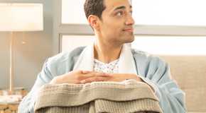 Freddy Miyares as Dorian Cardenas holds a box and a blanket on Grey's Anatomy