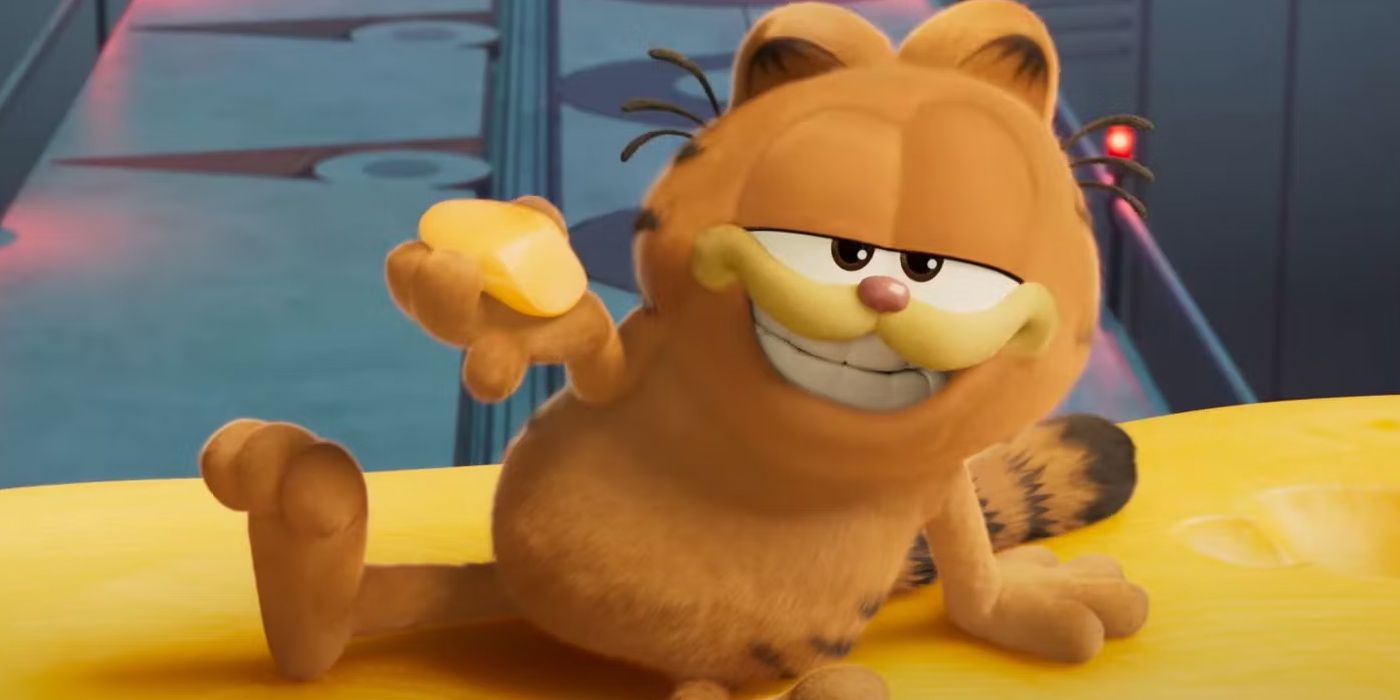 Garfield smiles while holding cheese in The Garfield Movie