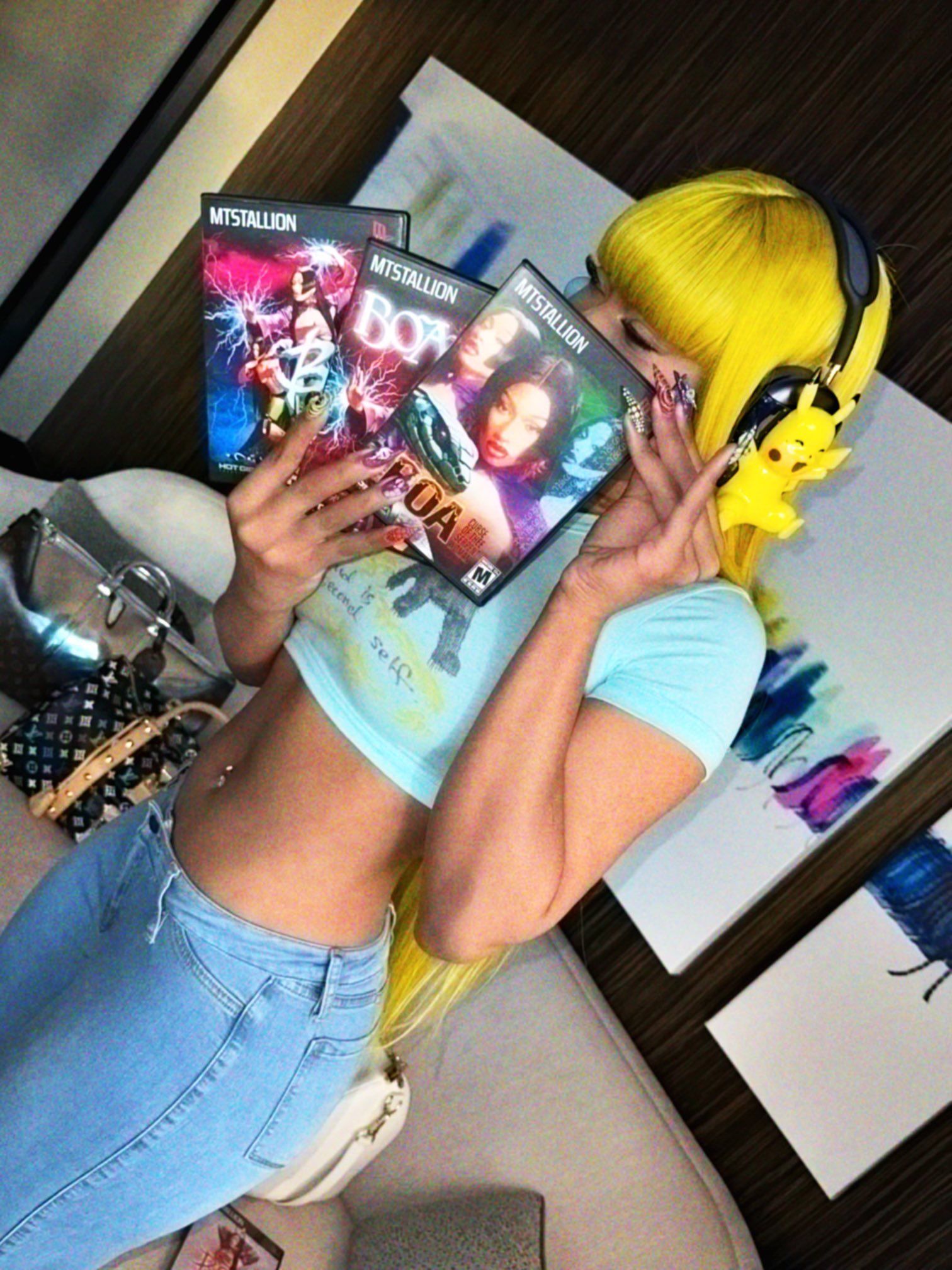 Megan Thee Stallion holding her Boa Hancock cosplay PS2 covers
