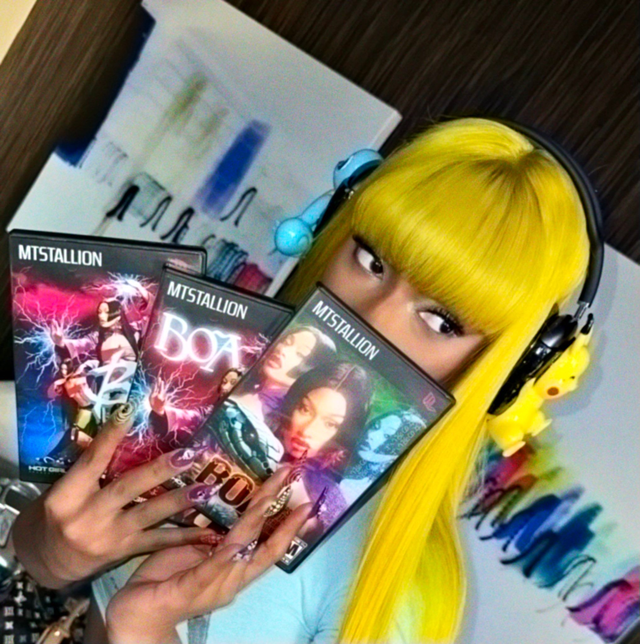 Close-up of Megan Thee Stallion holding her Boa Hancock cosplay PS2 covers