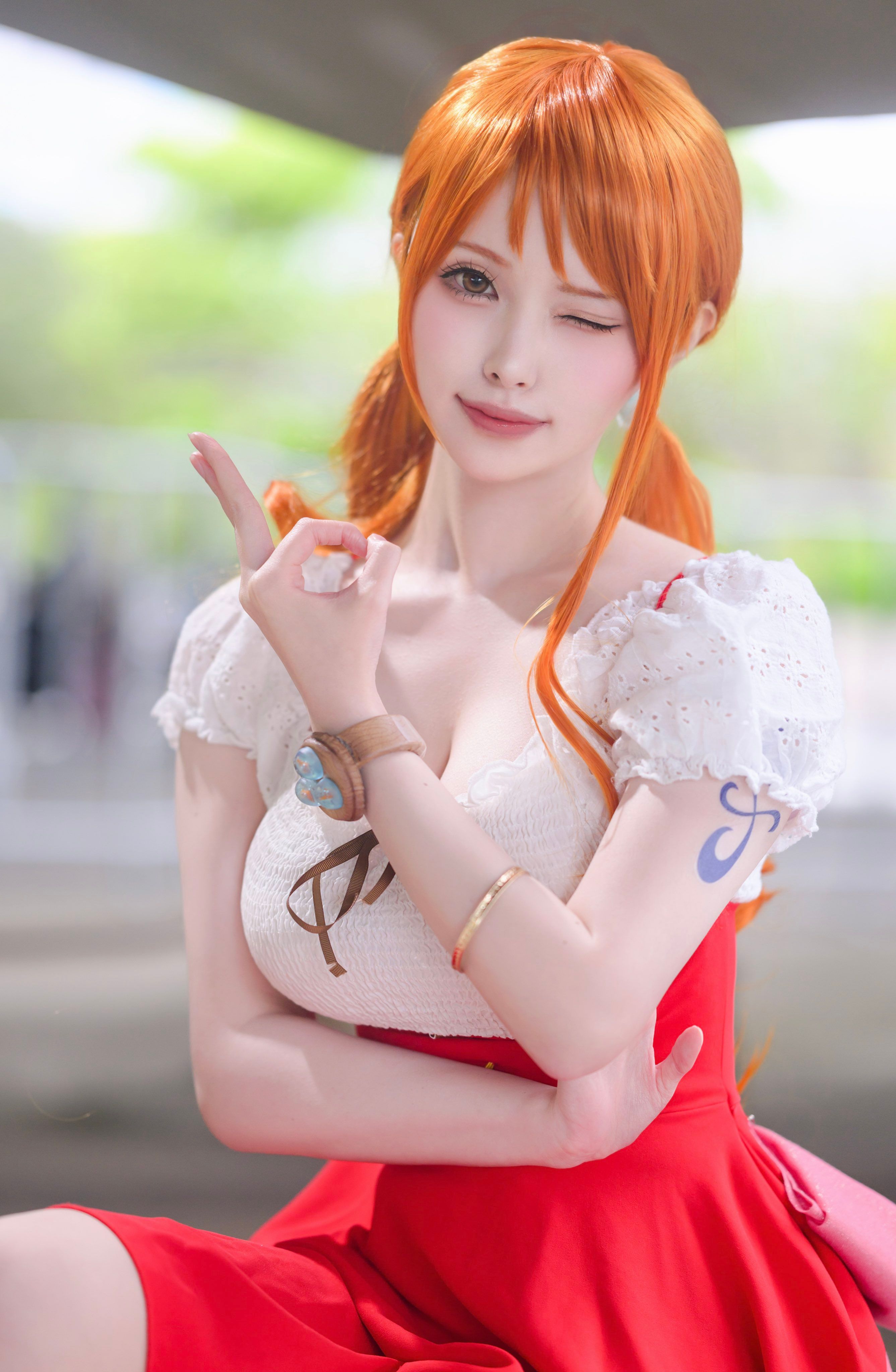 3/4 winking headshot of Nami One Piece anime cosplayer from Whole Cake Island arc