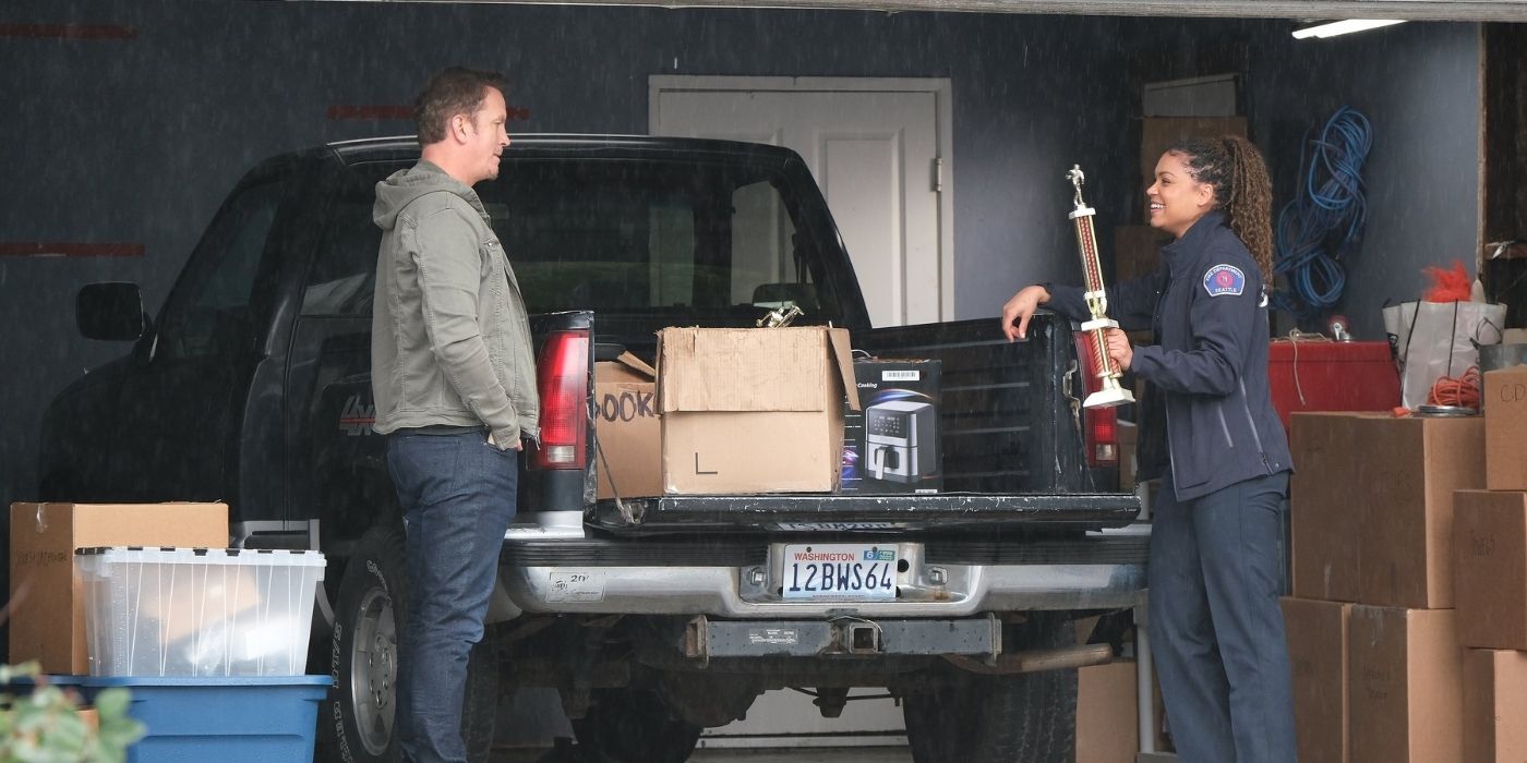 Josh Randall as Sean Beckett watches as Barrett Doss as Victoria Hughes shows off a trophy on Station 19