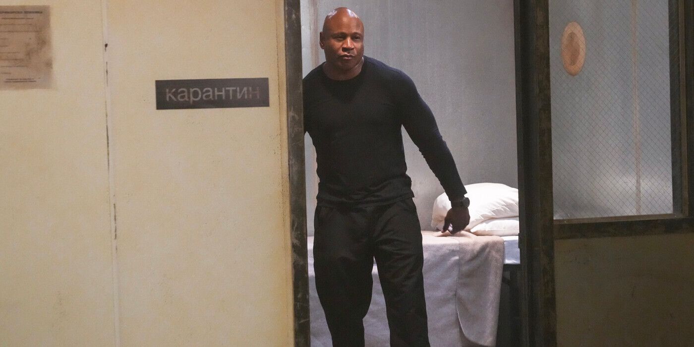 Sam Hanna (actor LL Cool J) leans in a doorway wearing all black in NCIS: Hawai'i