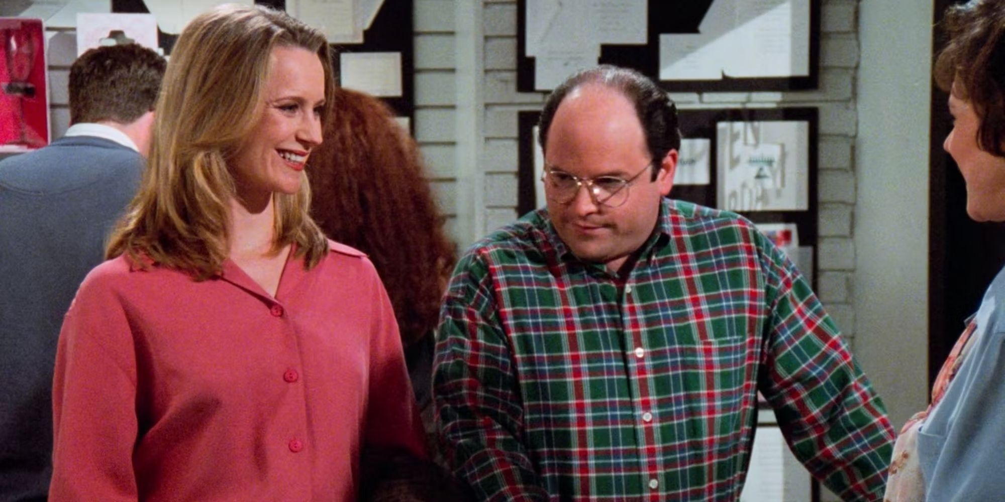 Heidi Swedberg's Susan Ross and Jason Alexander's George Costanza stand next to each other in Seinfeld