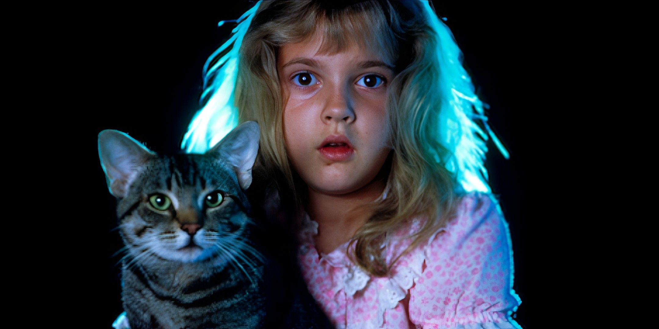 A young Drew Barrymore looking straight ahead shocked while holding a cat in Cat's Eye movie poster.
