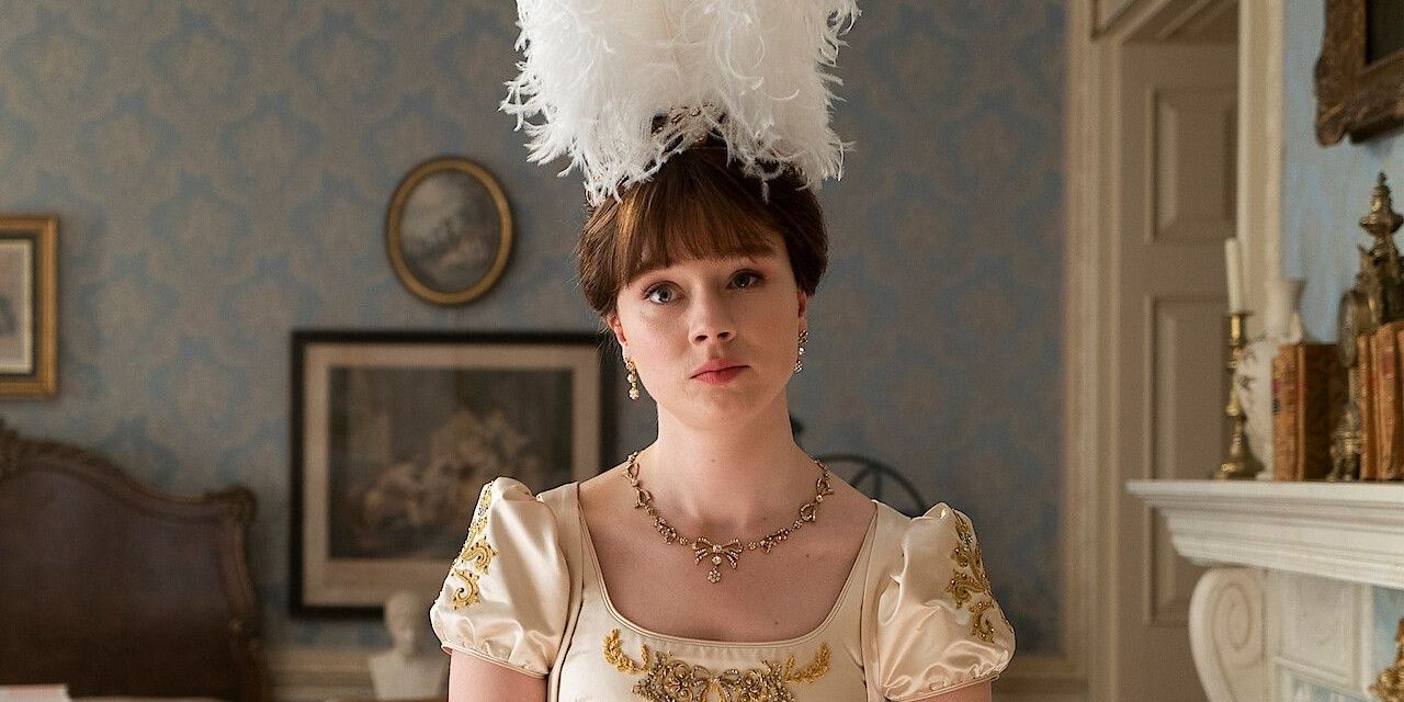 Eloise Bridgerton at her home, looking upset with a feather head piece and a formal dress