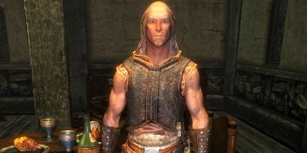 Belrand from Elder Scrolls V: Skyrim is standing and staring at the camera.