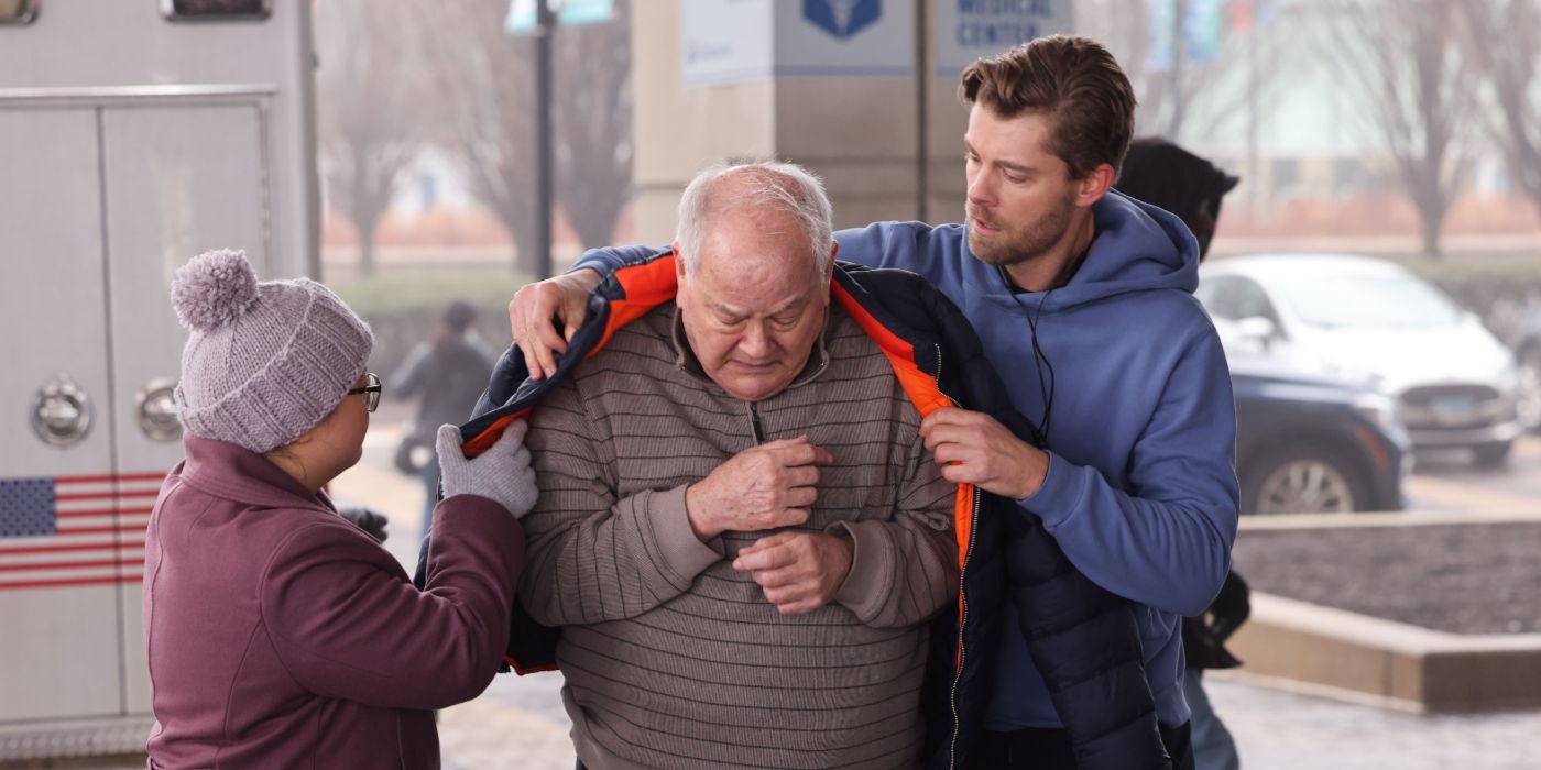 Dr. Mitch Ripley (actor Luke Mitchell) puts his coat on a patient in Chicago Med