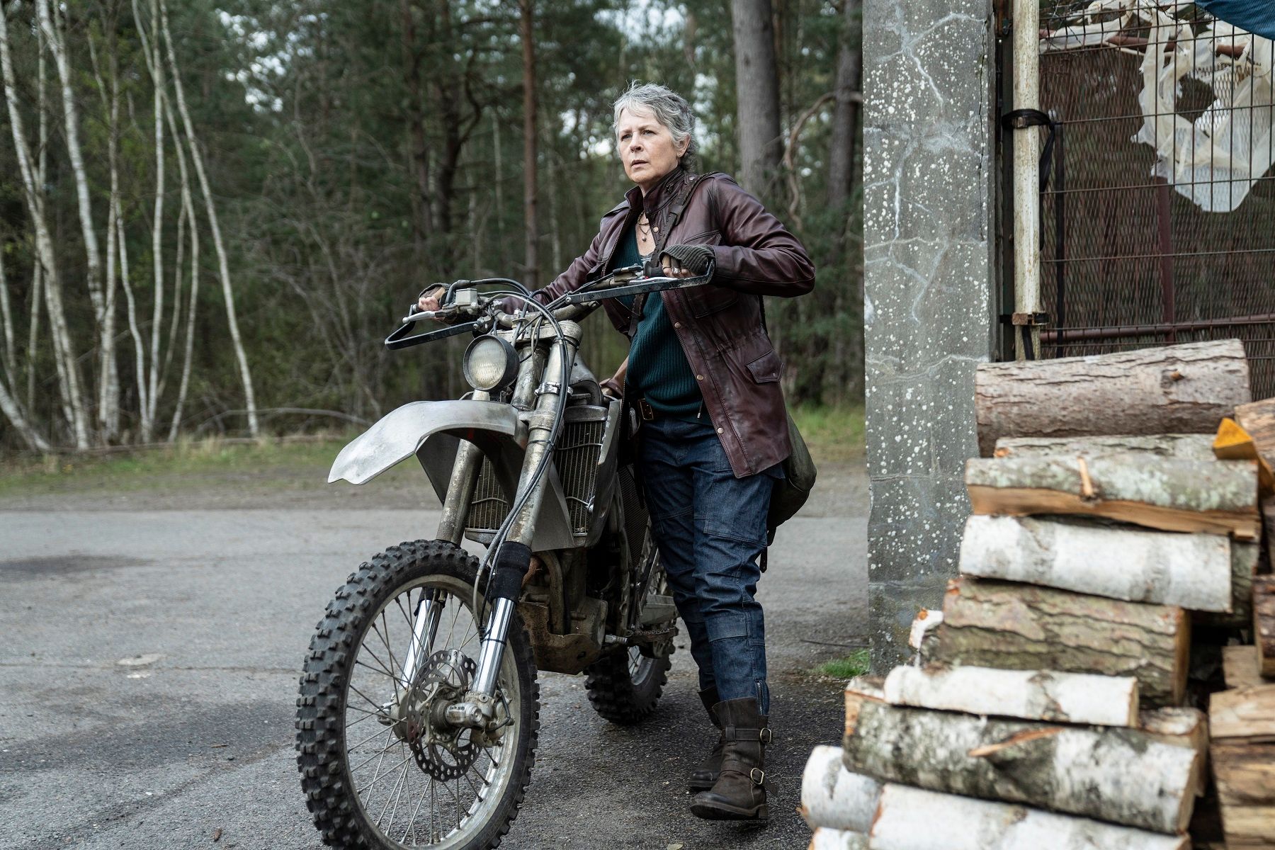 Melissa McBride as Carol Peletier with a motorcycle in The Walking Dead: Daryl Dixon - The Book of Carol Season 2