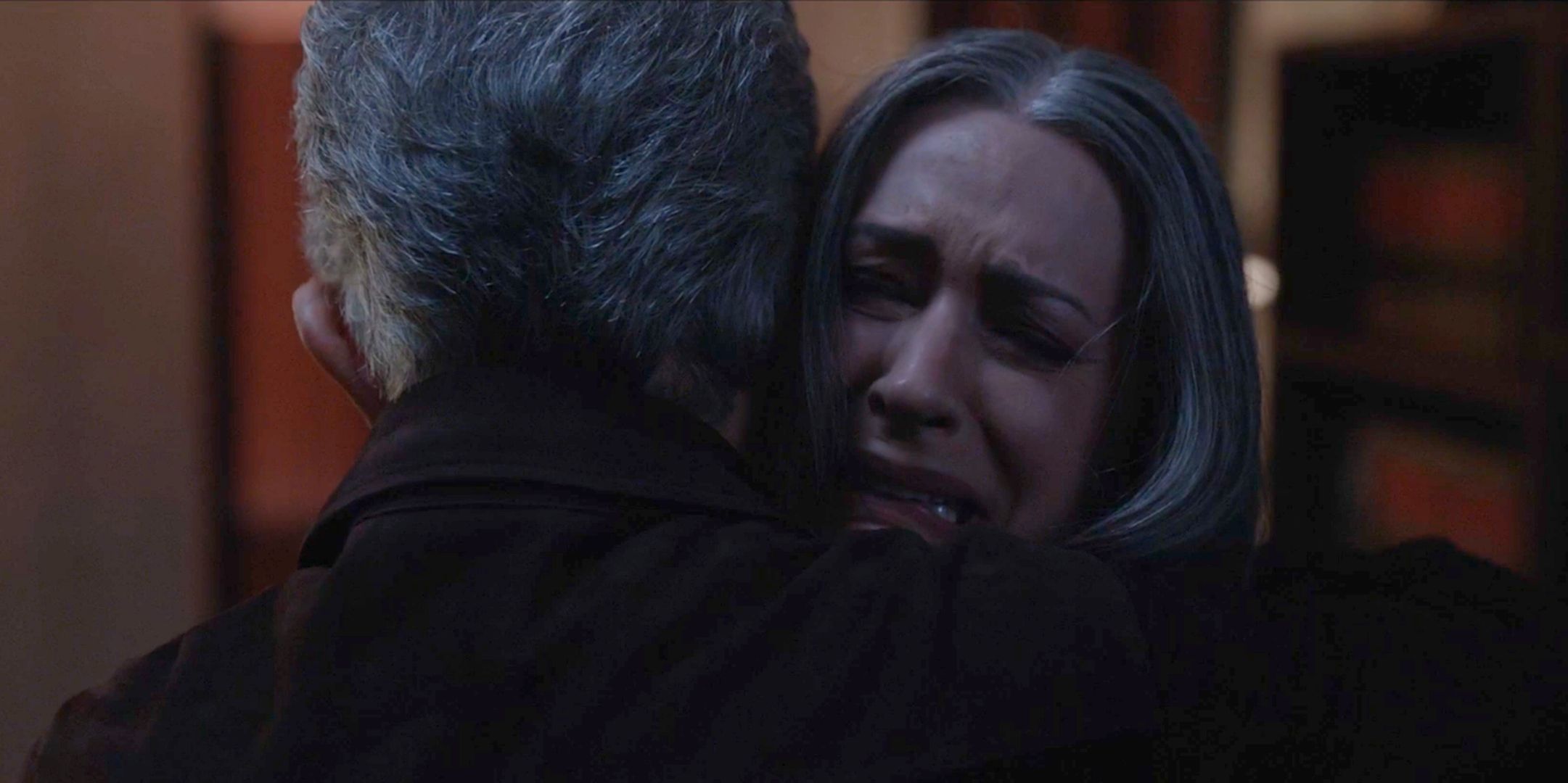 David Rossi, back to camera, hugs a crying Emily Prentiss in her office on Criminal Minds Evolution