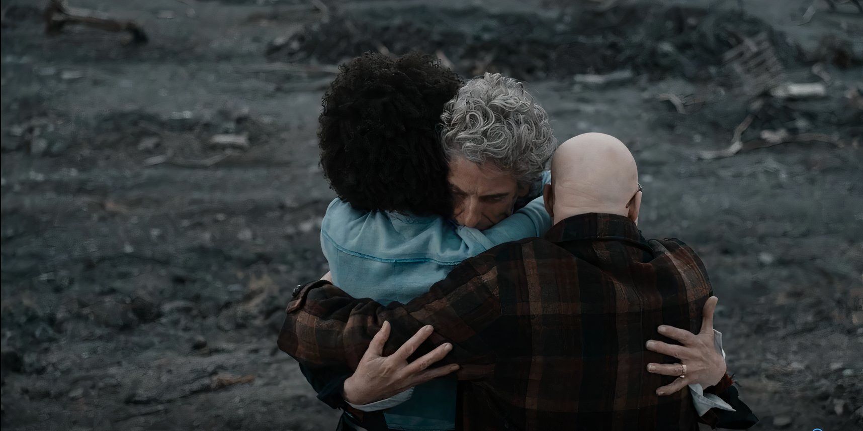 The Twelfth Doctor hugs Glass Avatars of Bill Potts and Nardole in Doctor Who: Twice Upon A Time.