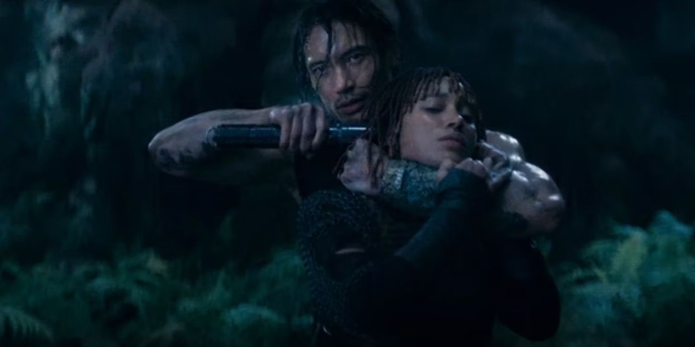 Qmir (Manny Jacinto), a.k.a. the Master, aims a lightsaber at Mae's (Amandla Stenberg) head in The Acolyte