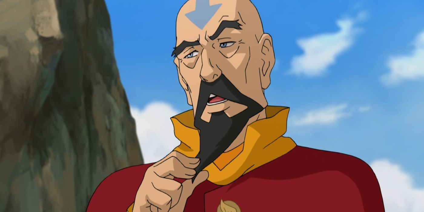 Tenzin talks while fidding with his beard.