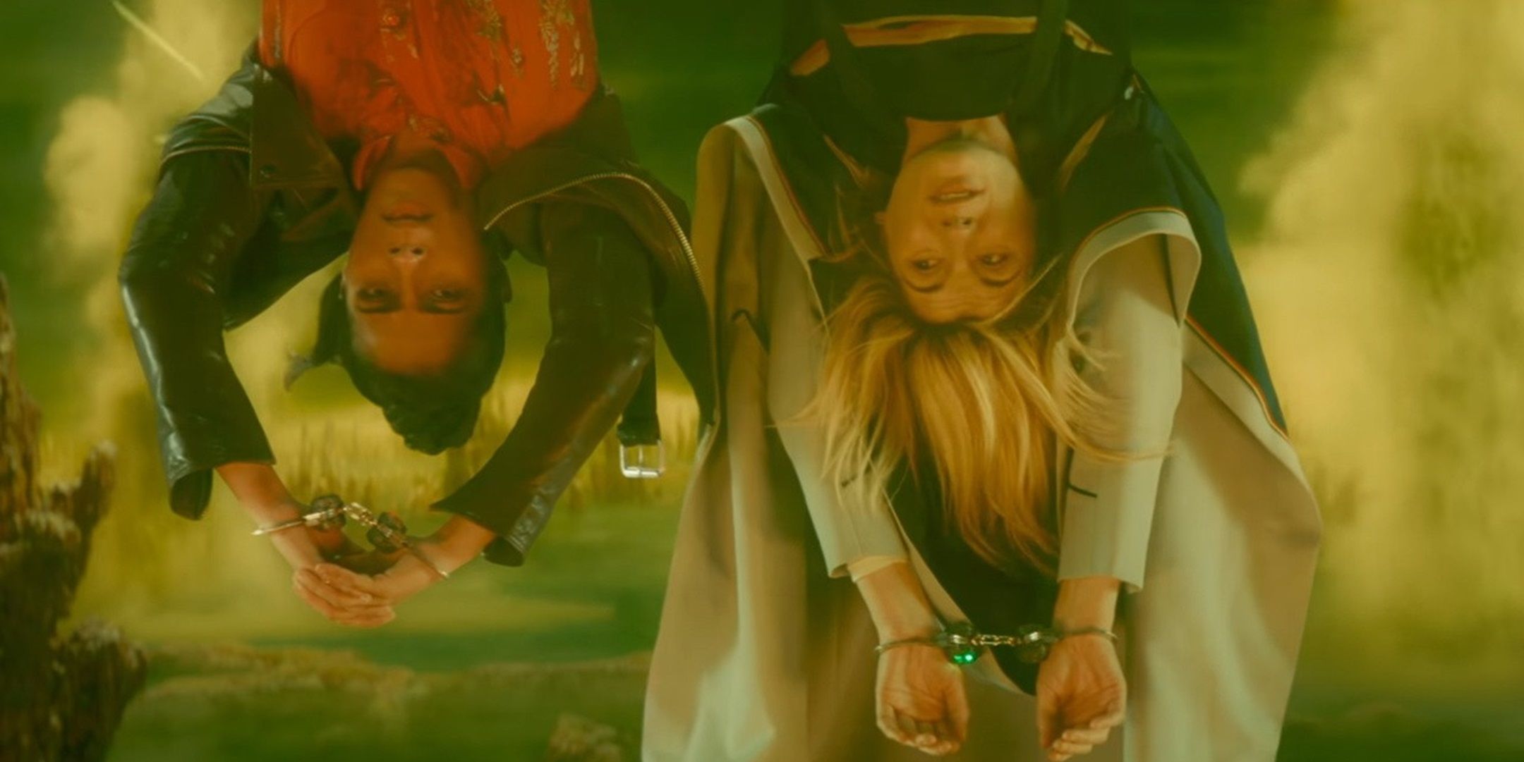 The Thirteenth Doctor and Yaz Yazmin Skhan hanging upside down from Doctor Who Flux