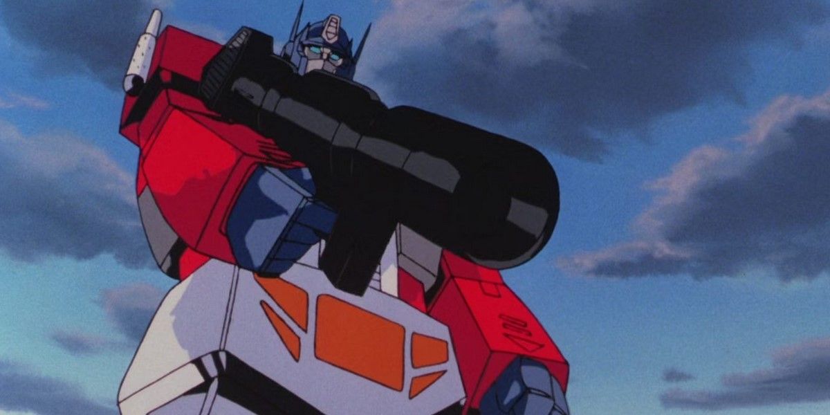 The Transformers The Movie – Optimus Prime se posiciona sobre Megatron, arma apontada para baixo