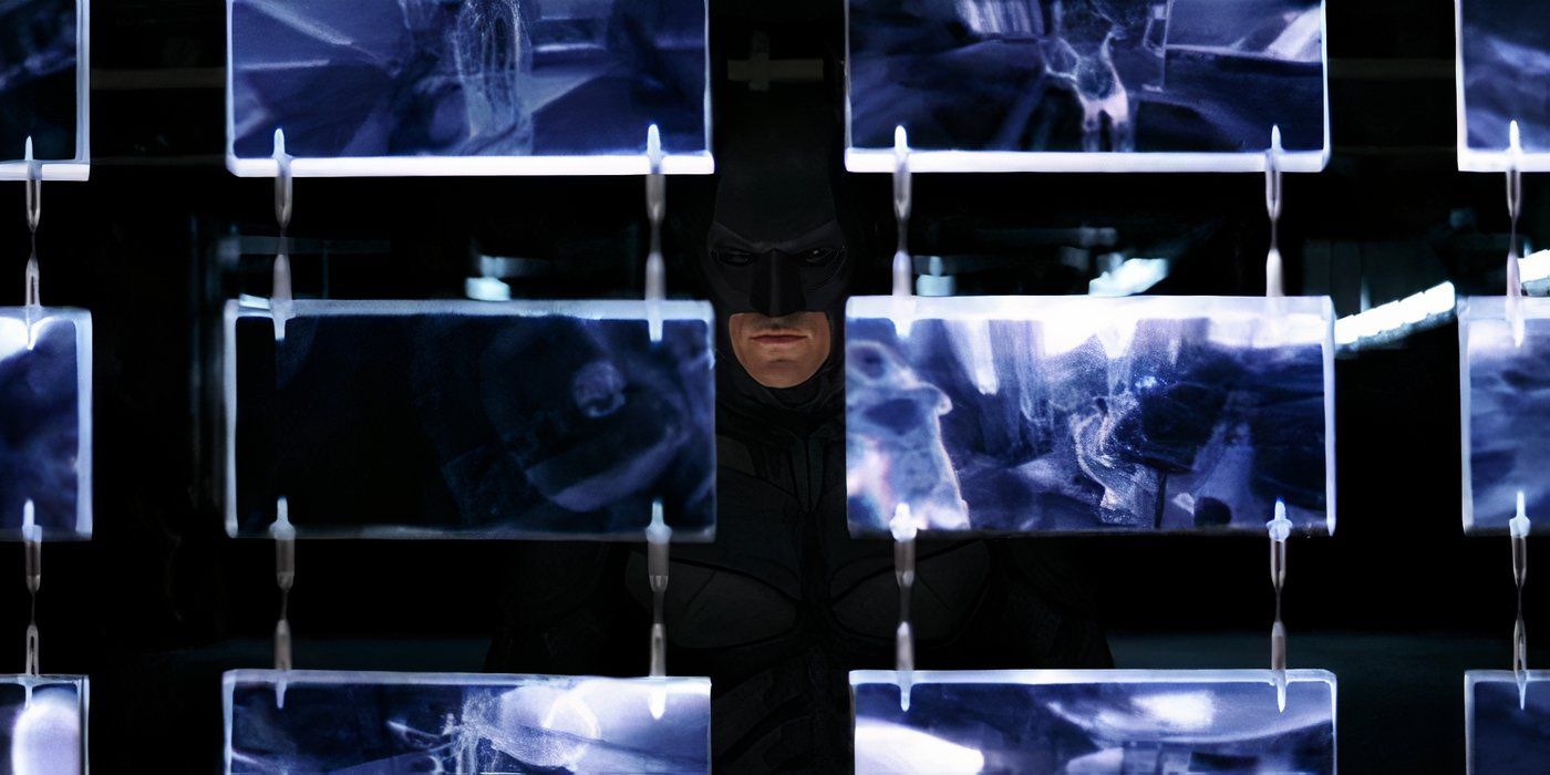 Christian Bale's Batman looks out of computer screens in The Dark Knight