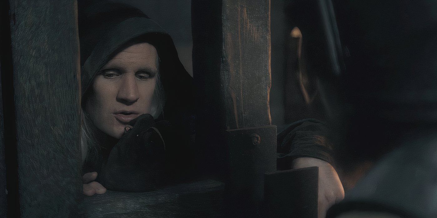 Daemon Targaryen (Matt smith) speaking through a gate, offering a purse of money in House of the Dragon