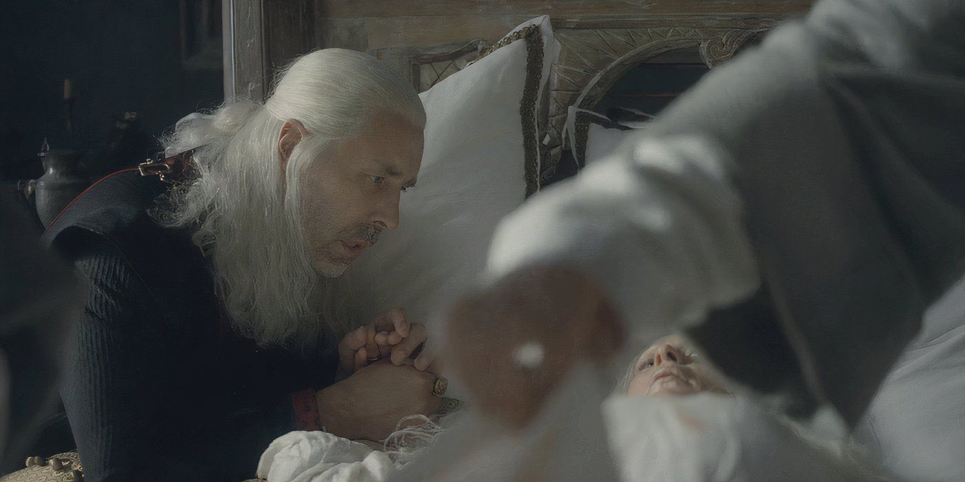 Viserys holding Aemma's hand as she lies in bed