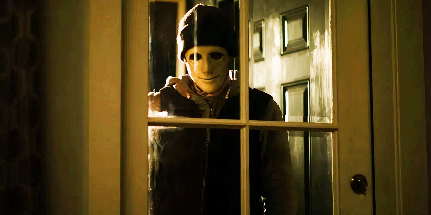 Hush film photo of masked man staring through a window