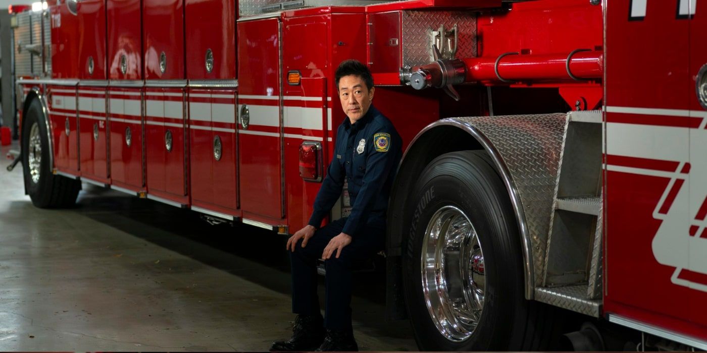 Kenneth Choi is sat by a fire truck in a 9-1-1 still