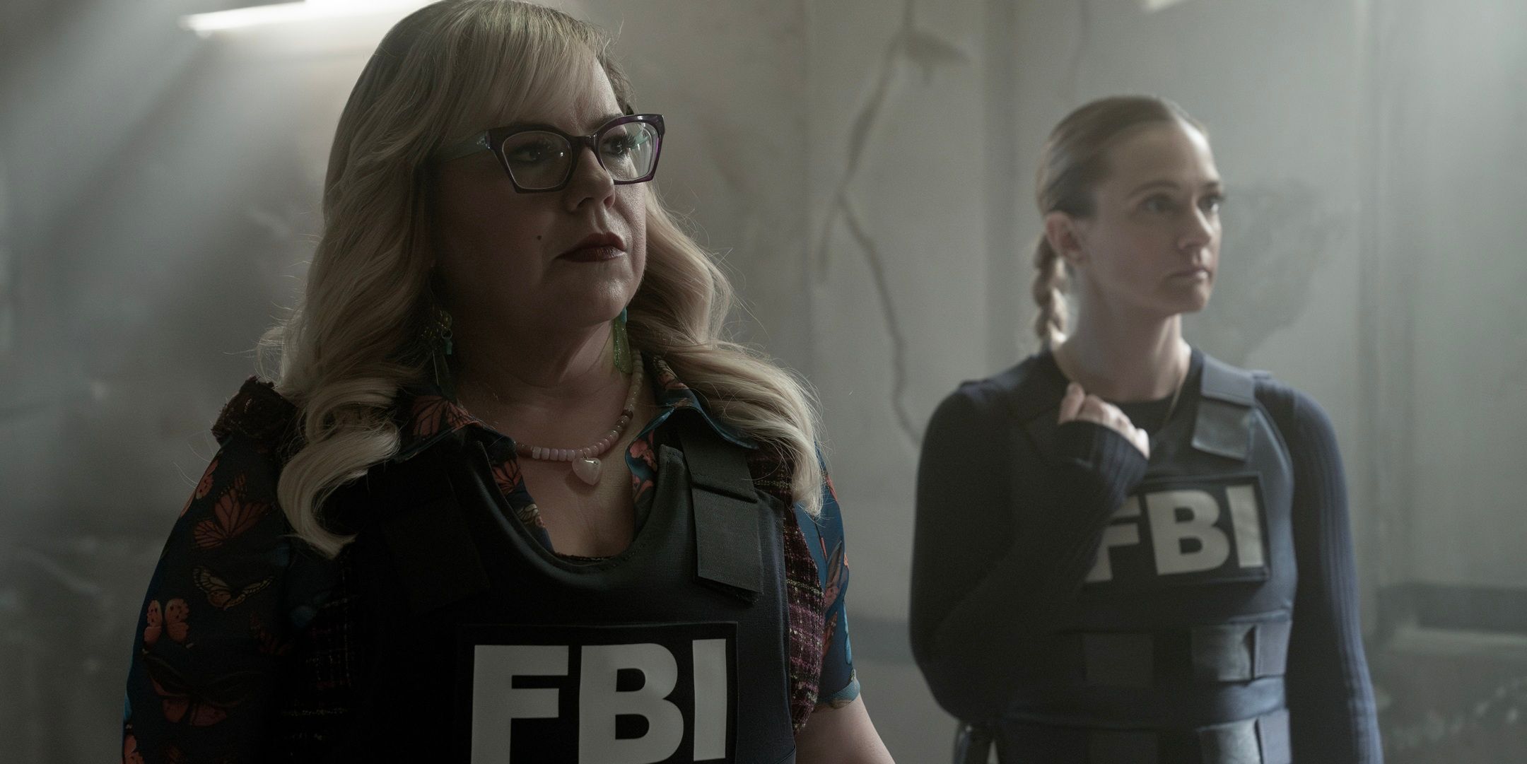 Garcia (Kirsten Vangsness) and JJ (AJ Cook) in FBI vests in dingy room in Criminal Minds: Evolution