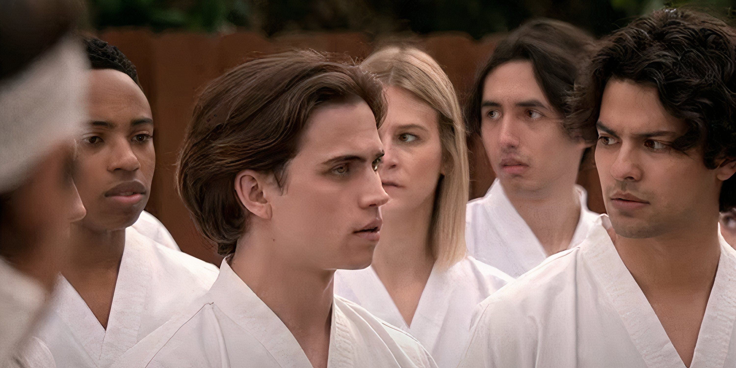 Robby (Tanner Buchanan) and Miguel (Xolo Mariduena) look at each other in karate gis in Cobra Kai