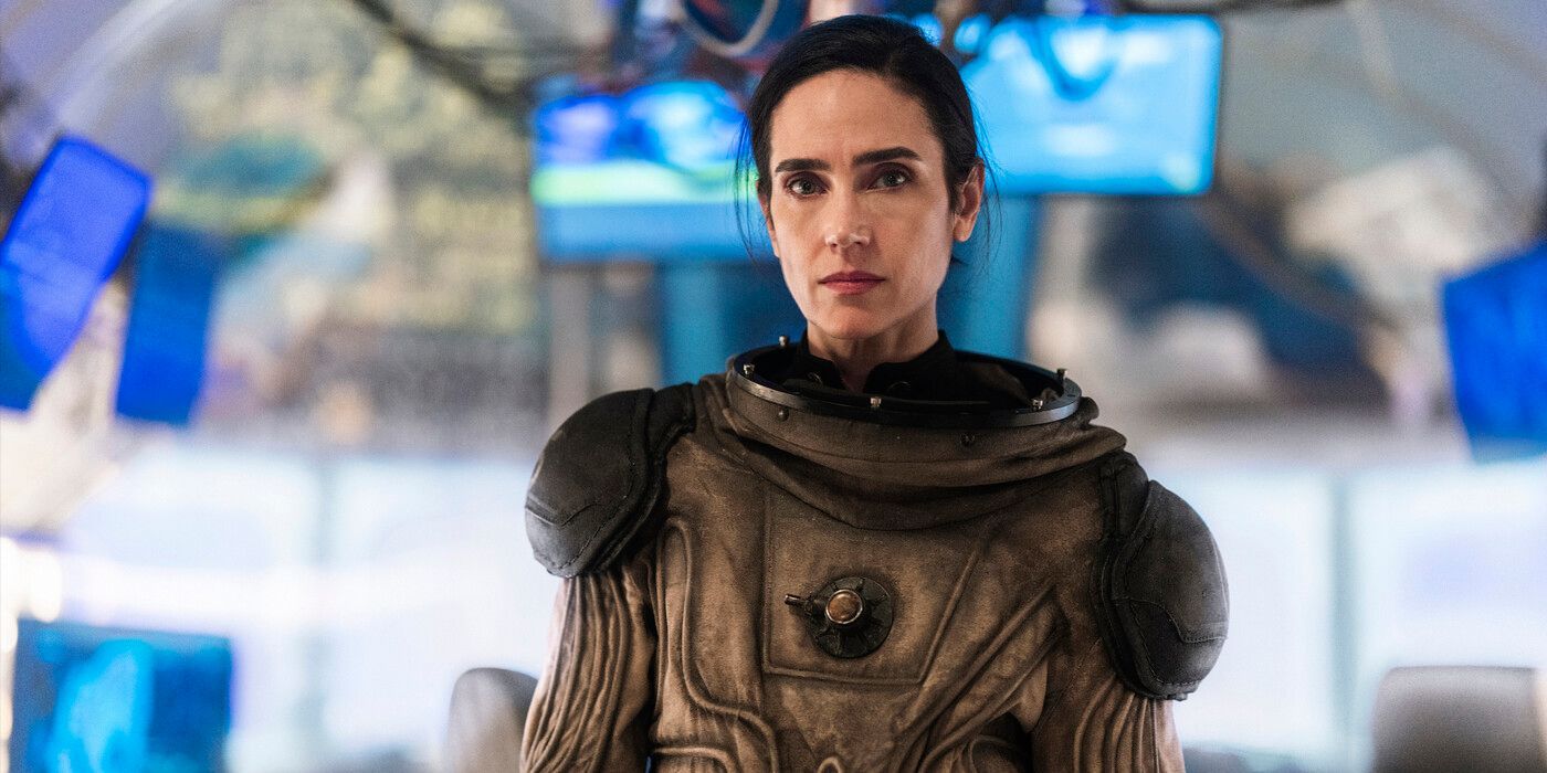 Melanie Cavill (actor Jennifer Connelly) stands in a brown exosuit in Snowpiercer Season 4