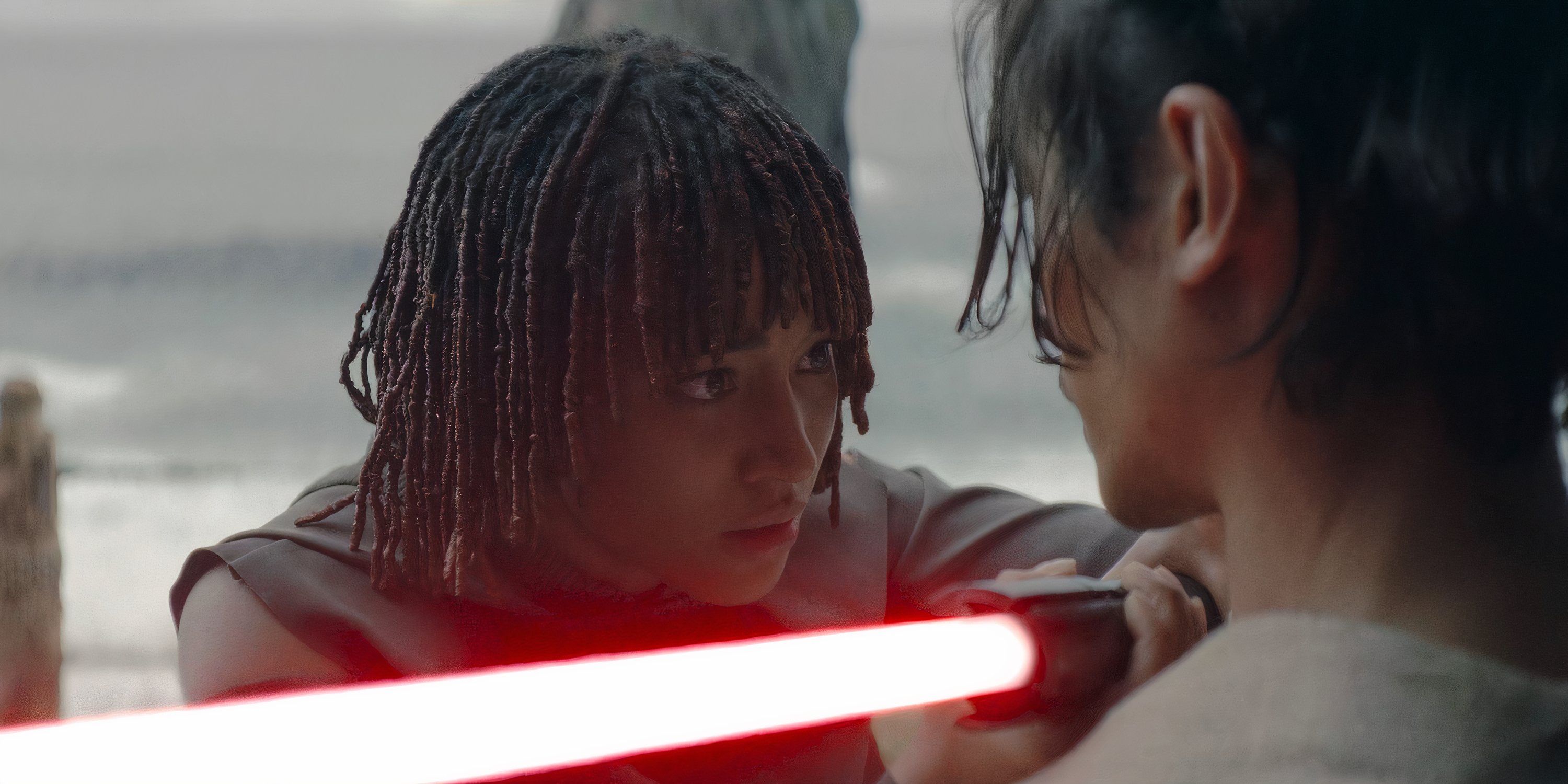 Osha (Amandla Stenberg) holds a lightsaber against Qimir (Manny Jacinto) in The Acolyte