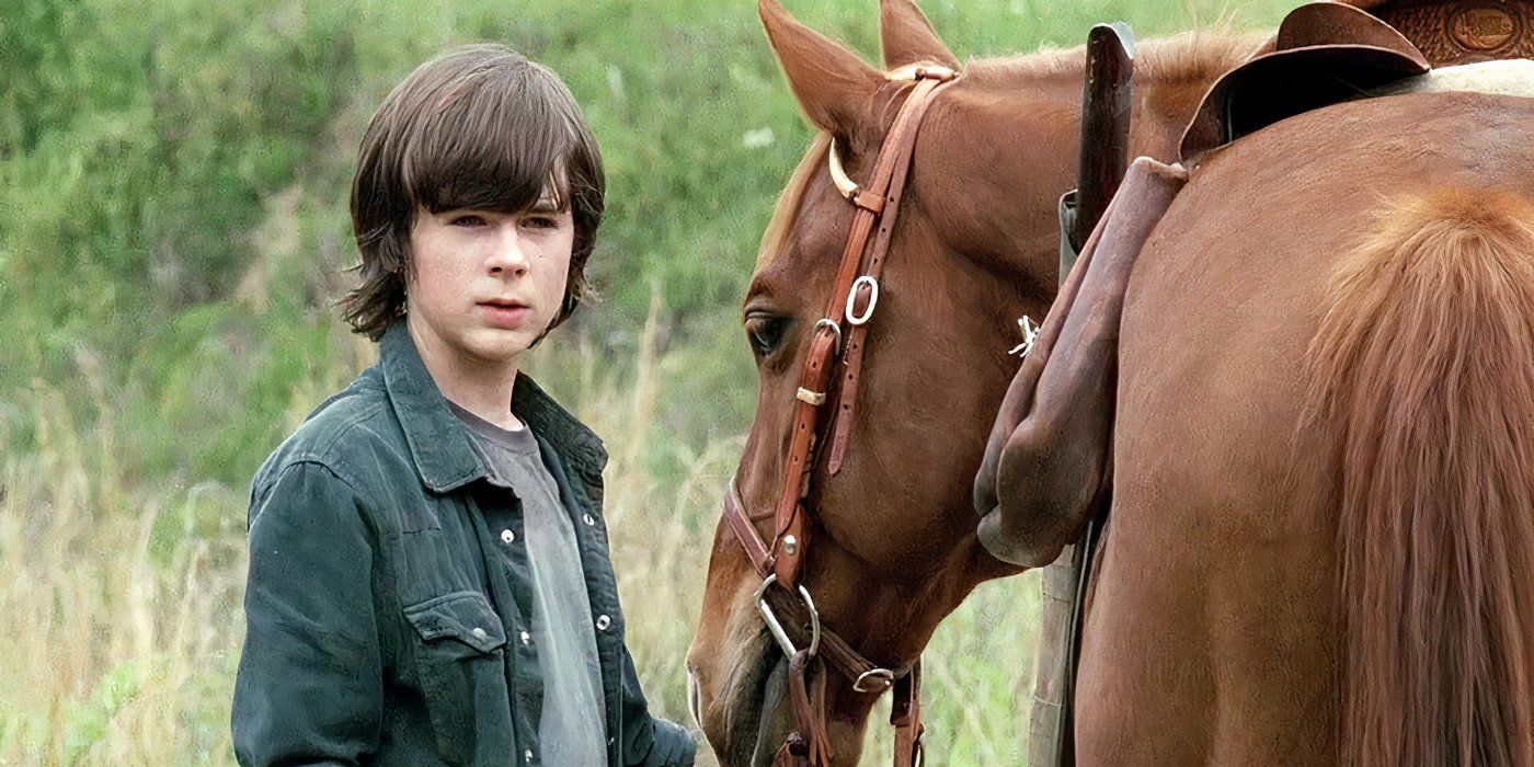 A young Carl from The Walking Dead standing beside a horse.