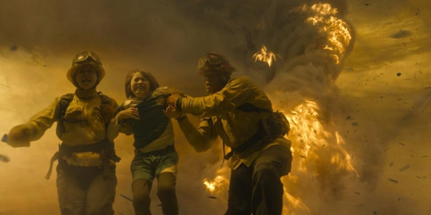 Stephanie Arcila as Gabriela Perez and Jordan Calloway as Jake Crawford carry a child away from a tornado on Fire Country