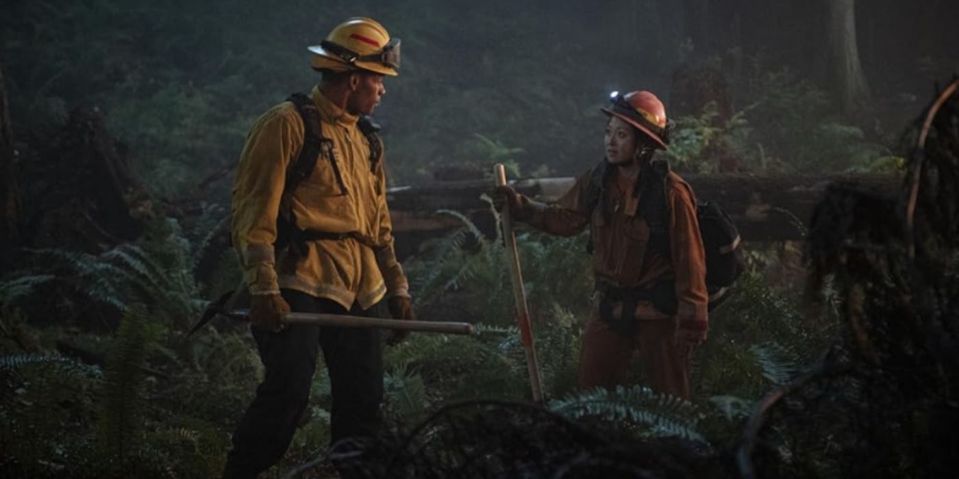 Jordan Calloway as Jake Crawford talks with Fiona Rene as Rebecca Lee in the woods on Fire Country