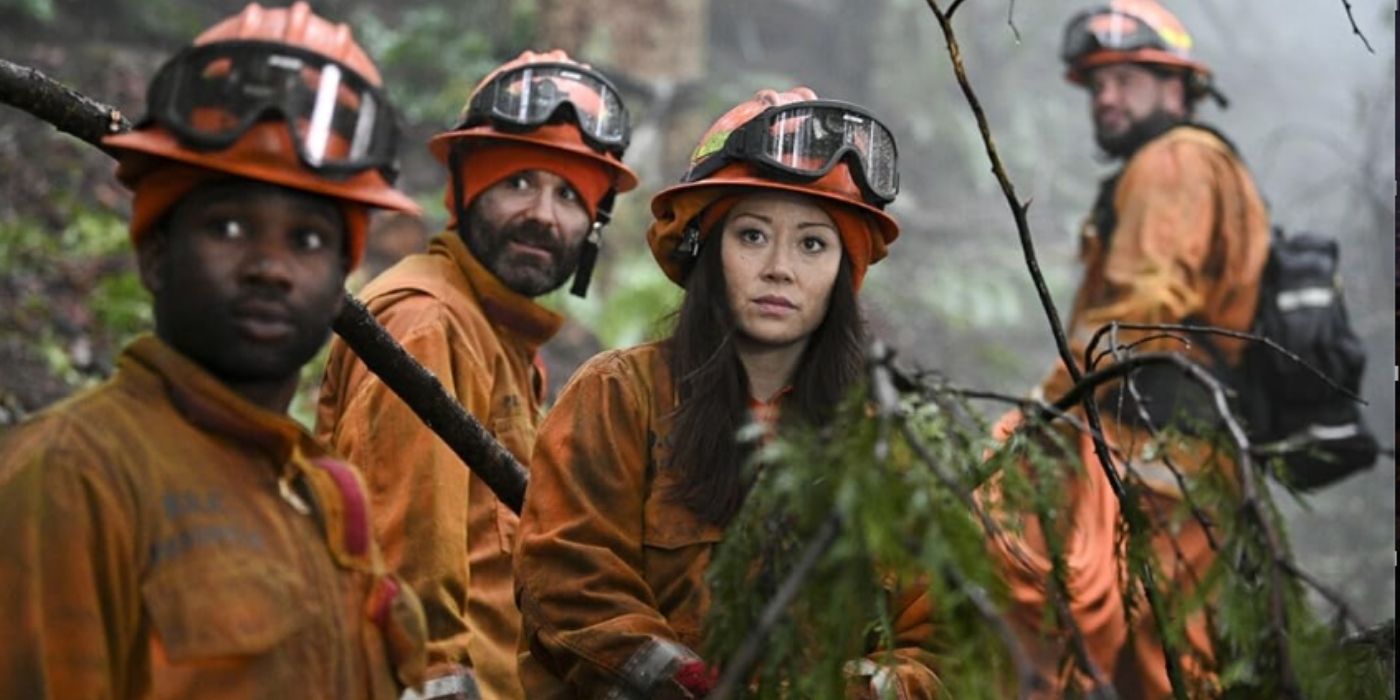 W. Tré Davis as Freddy Mills and Fiona Rene as Rebecca Lee stands in the woods with other inmate firefighters on Fire Country