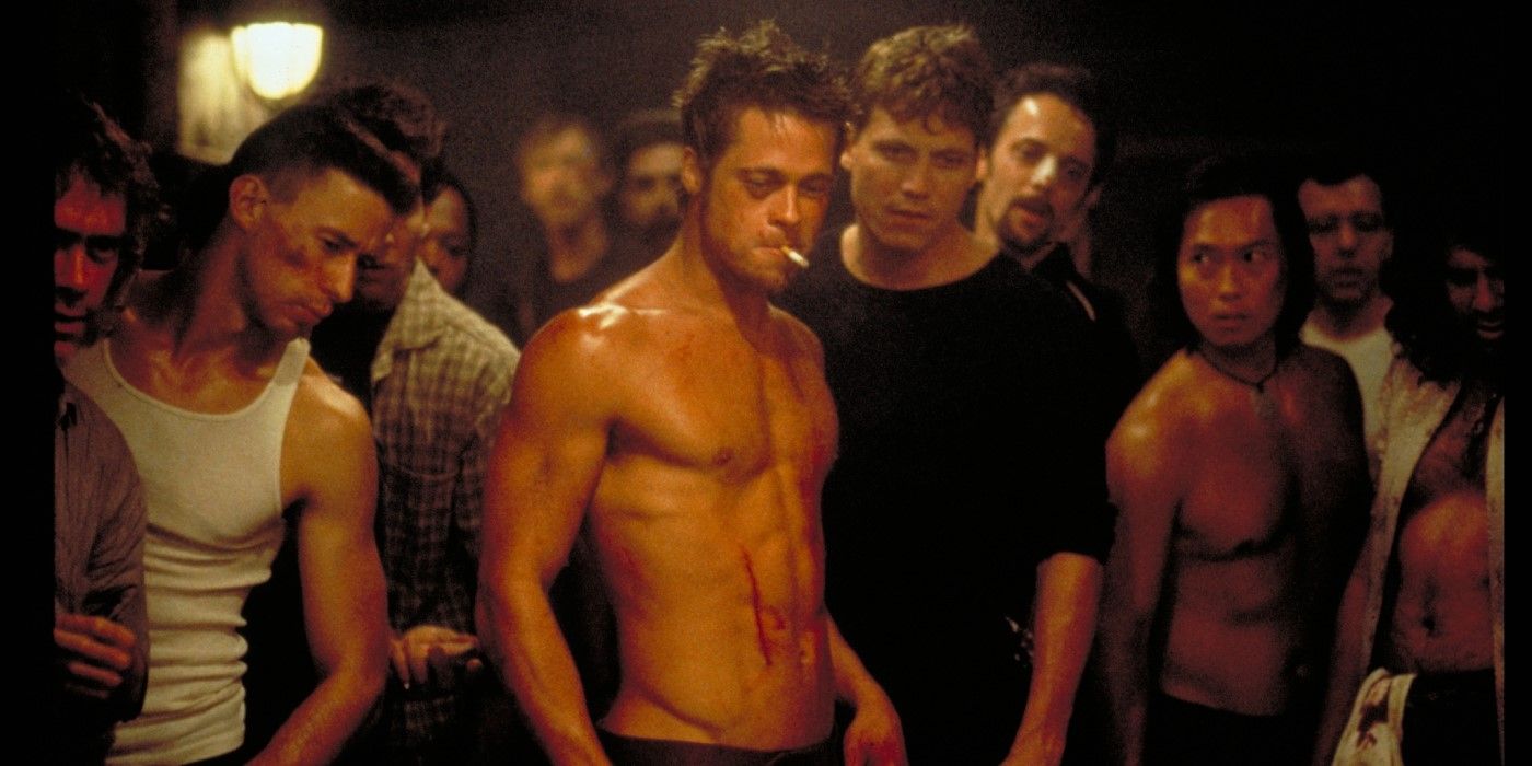 Tyler Durden (actor Brad Pitt) is shirtless and surrounded by people in the movie Fight Club