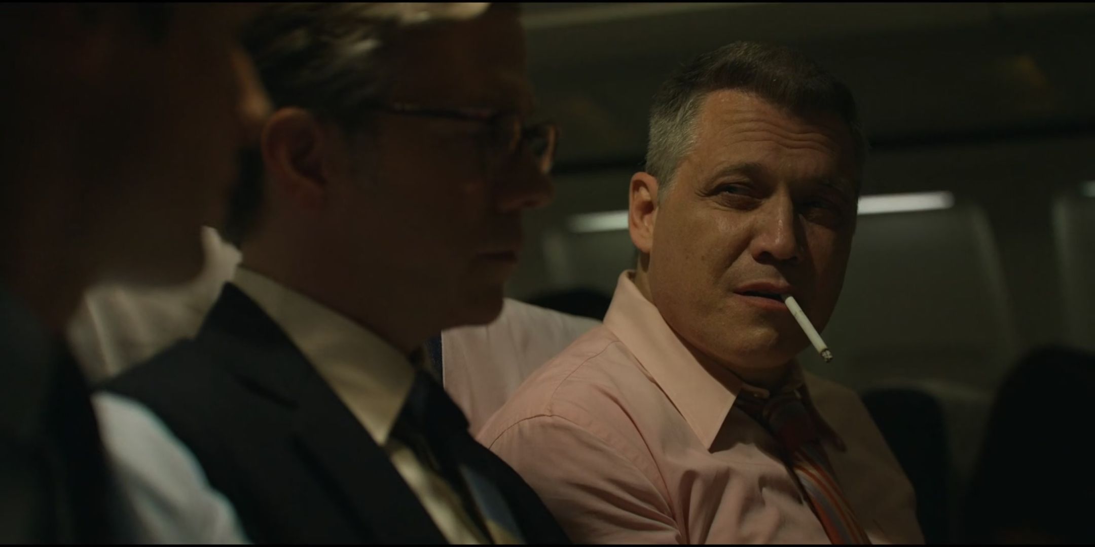 Holt McCallany as Bill Tench holds a cigarette in his mouth in Mindhunter