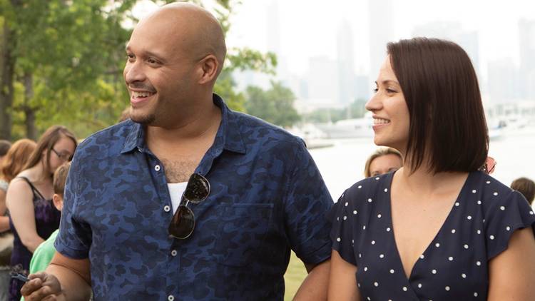 Joe Miñoso as Joe Cruz and Kristen Gutoskie as Chloe Cruz smile at someone off camera on Chicago Fire