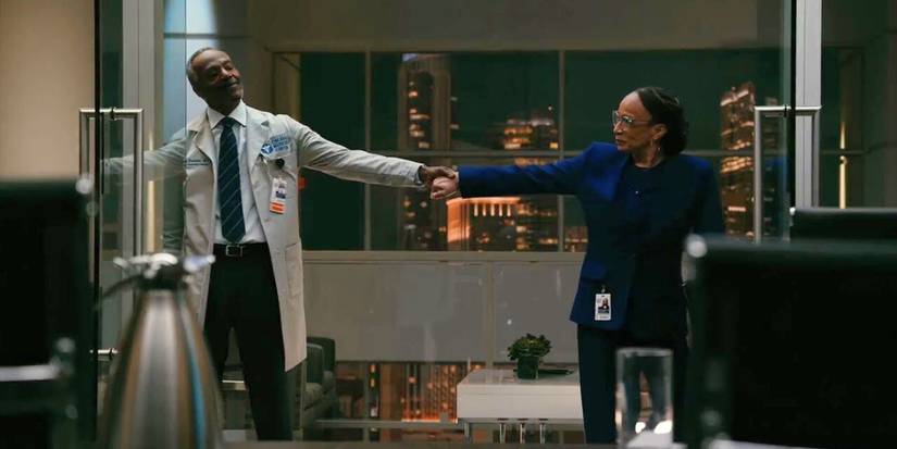 John Earl Jelks as Dennis Washington holds hands with S. Epatha Merkerson as Sharon Goodwin on Chicago Med