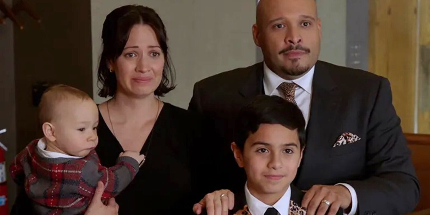 Kristen Gutoskie as Chloe Cruz holds baby Otis while standing next to Joe Miñoso as Joe Cruz who stands behind Carlos S. Sanchez as Javi in the court room on Chicago Fire