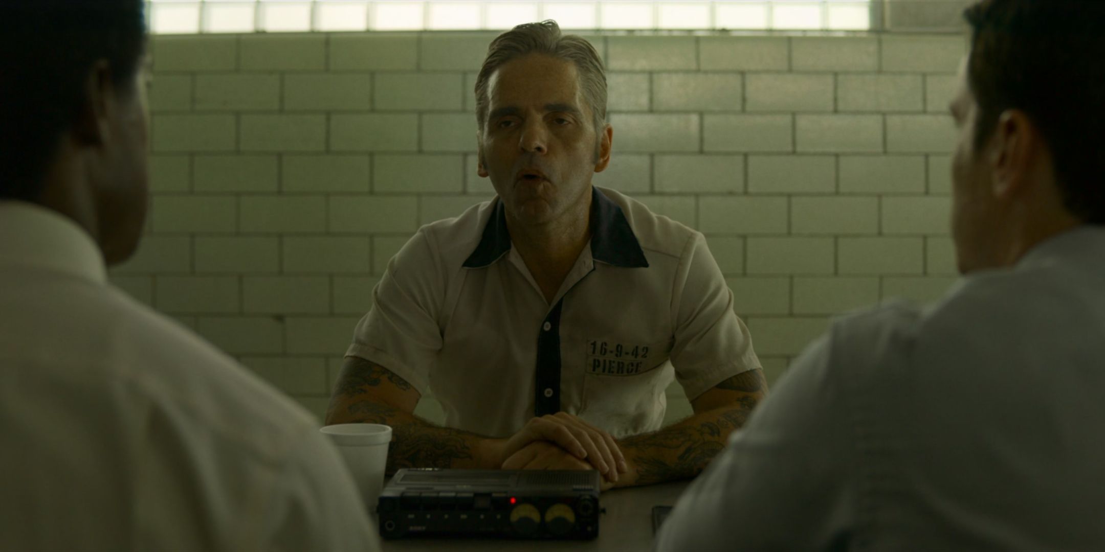 Michael Filipowich as William Junior Pierce talks to Jonathan Groff as Holden Ford and Albert Jones as Jim Barney in Mindhunter